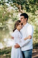 guy and a girl walk along the paths of a forest park photo