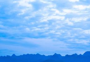 Blue clouds over the mountain in evening time photo