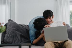 joven pareja gay asiática proponer en casa moderna, hombres lgbtq coreanos adolescentes felices sonriendo tienen tiempo romántico mientras proponen y matrimonio sorpresa usan anillo de bodas en la sala de estar en el concepto de casa.