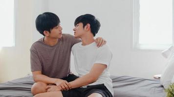 Asian Gay couple kissing on bed at home. Young Asian LGBTQ men happy relax rest together spend romantic time after wake up in bedroom at home in the morning concept. photo
