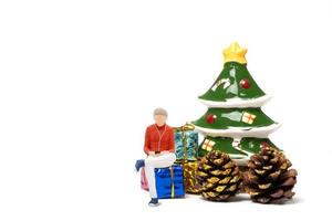 Miniature people , Woman wearing headphones sitting on gift box photo