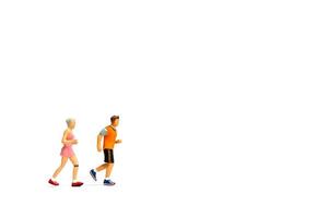 Miniature people running on white background photo