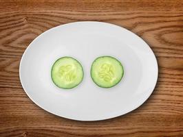 Cucumber in the white plate  on wooden table
