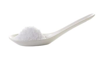 sea salt in spoon on white background photo