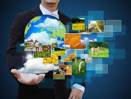 businessman holding green Earth in hands and Reaching images streaming .Environmental concept photo