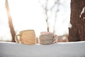 Two cups of tea on background of a winter landscape photo