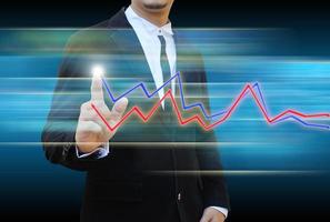 businessman hand pushing a business graph photo