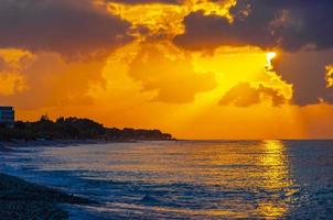 The most beautiful colorful golden sunset Ialysos Beach Rhodes Greece. photo