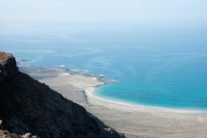 Coastline of Lanzarote seen from Mirador del Rio on a sunny day.Canary islands, Spain. photo
