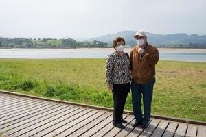 Aged caucasian couple 70-80 in a beautiful natural environment. Rodiles Natural Reserve, Asturias photo