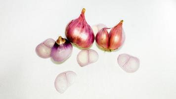 Red whole onion with cut slices isolated on a white background photo