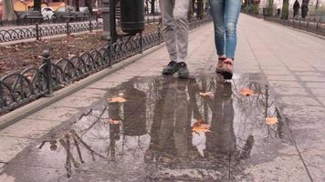 Feet in Boots Over a Puddle video