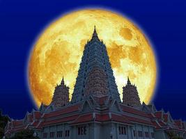 Super blood moon over Buddhagaya pagoda on night sky photo