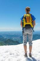 Girl looking at the horizon from a mountain photo