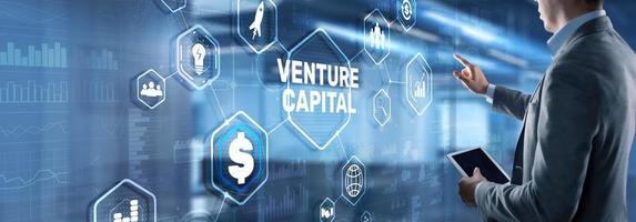 Venture capital. Investor capital. Businessman pressing virtual screen inscription photo