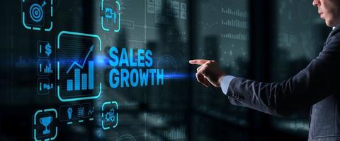 Sales Growth Man clicks inscription on virtual 3D screen photo