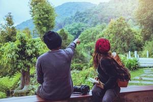 Asian couple travel photograph nature education. nature relax and study read a book. at public park. In Thailand photo