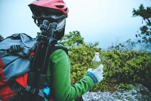 Asian woman Travel photograph Nature. travel relax in the holiday walk in the forest. on a rocky cliff. Thailand photo