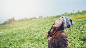 Asian women relax in the holiday. Stand in the cold winter garden. Mountain Park happily. In thailand photo