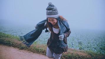 Asian women relax in the holiday. Happy to travel in the holiday. During the foggy winter