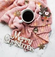 Cup of coffe, sweater and garland photo