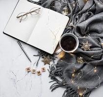 Notebook, scarf, coffe and garland photo