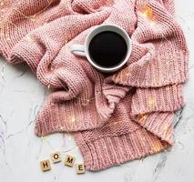 Cup of coffe, sweater and garland photo