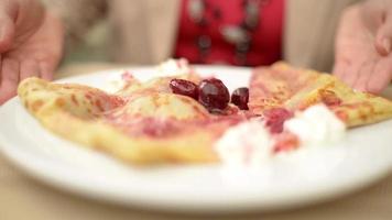 Eating pancakes with cherries - with a knife and fork video
