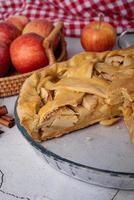 Top view of homemade apple pie on wooden table photo