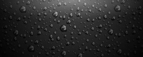 Gotas de agua sobre fondo de cristal negro