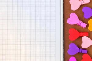 White paper and small colored hearts. Note to the Valentine's Day photo