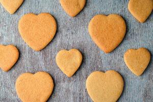 A pattern of ginger biscuits on a gray wooden table. photo