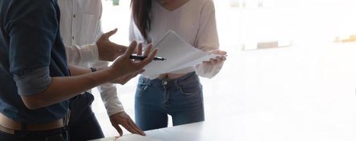 Businesswoman holding pens and holding graph paper are meeting to plan sales to meet targets set in next year. photo