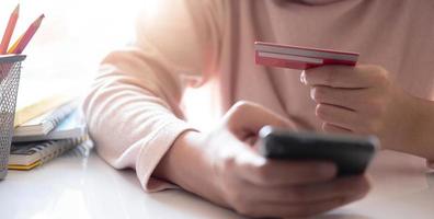 Online payment,Man's hands holding smartphone and using credit card for online shopping. Cyber Monday Concept photo