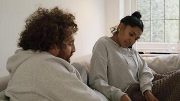 Woman and man on sofa looking in magazine video