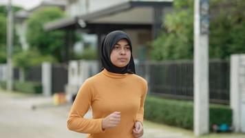 Muslim teenage girl jogging In her village in the evening