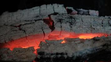 Heat and hot coals from firewood. Firewood burning in the fireplace video