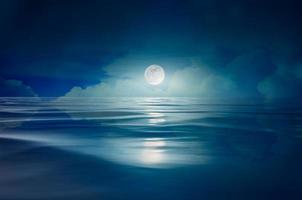 full moon in the sea at night photo