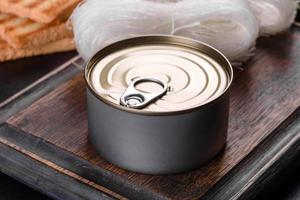 Canned delicious fresh tuna in oil with salt and spices in a tin can photo