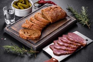 Delicious fresh bacon sliced with bread and vegetables photo