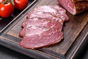 Delicious fresh bacon sliced with bread and vegetables photo