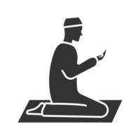 Praying muslim man glyph icon. Worship. Islamic culture. Silhouette symbol. Negative space. Vector isolated illustration