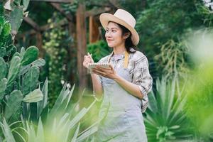 Young Asian woman takes care of the garden photo