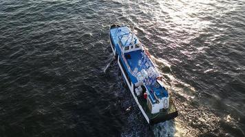 Aerial view of the seascape with a small boat photo