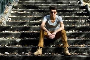 Attractive young handsome man, model of fashion in stairs photo