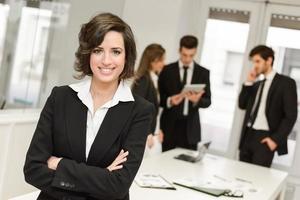 Business leader looking at camera in working environment photo