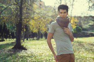 Attractive young handsome man, model of fashion in the park photo