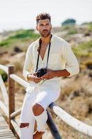 Handsome man photographing in a coastal area. photo