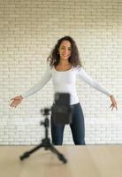 Latin woman created her dancing video by smartphone camera. To share video to social media application. photo