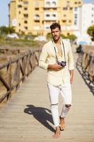 Handsome man photographing in a coastal area. photo